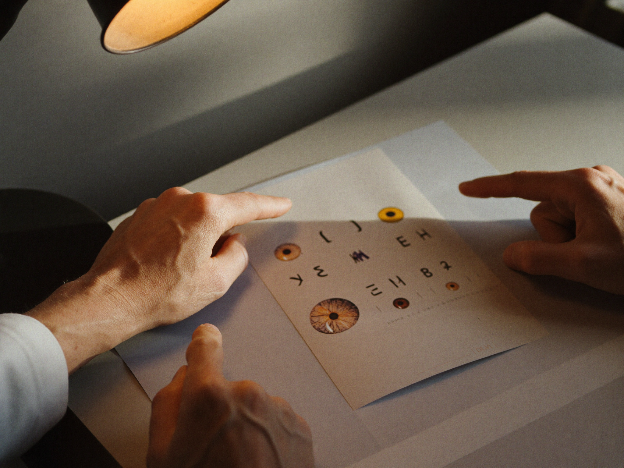 A mentor explaining an approach to a younger ophthalmologist